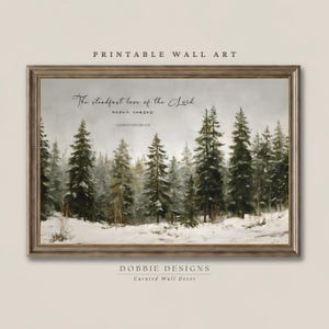 May include: A framed wall art print featuring a snowy forest landscape with evergreen trees. The text reads: The steadfast love of the Lord never ceases. LAMENTATIONS 3:22. The image is labeled PRINTABLE WALL ART and DOBBIE DESIGNS Curated Wall Decor.