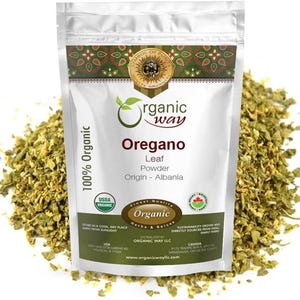 May include: A silver stand-up pouch of Organic Way Oregano Leaf Powder from Albania. The label features the text 100% Organic, USDA Organic, and Canada Organic logos. The pouch is surrounded by a pile of dried, light green, crushed oregano leaves.