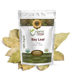 May include: A white pouch of "Organic Way" bay leaves with the text "Bay Leaf" and "Whole Origin - India". The pouch is surrounded by several dried bay leaves. The text "100% Organic" is also visible.