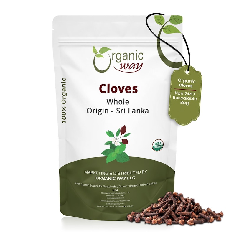 May include: A white resealable bag of whole cloves from Sri Lanka, with a green tag that reads "Organic Cloves". The bag has the "Organic Way" logo and the text "100% Organic". A pile of cloves is in front of the bag.