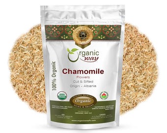 May include: A white resealable bag with a silver foil exterior. The bag contains dried chamomile flowers. The bag has a label with the text "Organic Way" and "Chamomile" in a green circle. The label also states "100% Organic", "Flowers", "Cut & Sifted", "Origin - Albania", "USDA Organic", "Organic Herbs & Spices", "Distributed by Organic Way LLC", and "www.organicwayllc.com".