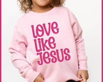 Peut inclure: Un sweat-shirt rose avec l'inscription "love like Jesus" imprimée en rose sur le devant.