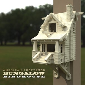 May include: A white birdhouse with a craftsman style design. It has a small porch, a chimney, and a roof with a slight overhang. The birdhouse is mounted on a wooden post. The text "AMERICAN CRAFTSMAN BUNGALOW BIRDHOUSE" is printed below the birdhouse.