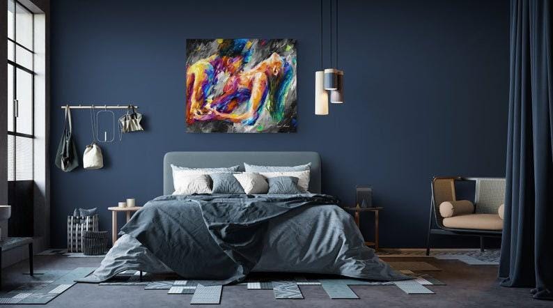 May include: A bedroom scene with a large abstract painting above a bed. The painting features figures in vibrant colors. The room has a blue color scheme, with a bed, side tables, and a chair. Decorative lighting hangs from the ceiling.