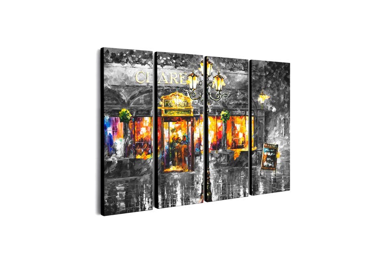May include: A four-panel canvas print depicting a nighttime street scene. The artwork is primarily in grayscale, with vibrant colors illuminating the interior of a building. The word "VOLARE" is visible above the entrance, and a menu board stands to the right.