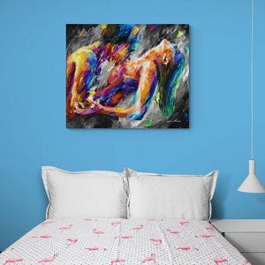 May include: Abstract art print depicting two figures in a passionate embrace. The artwork features a vibrant palette of blues, yellows, and purples against a dark, textured background. The figures are rendered with bold brushstrokes.