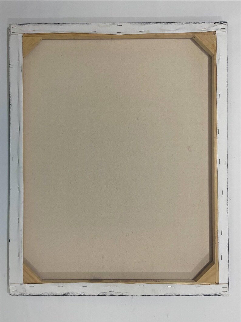 May include: Back of a stretched canvas art piece. The canvas is a light beige color, stretched over a wooden frame. The frame is visible, with the canvas wrapped around the edges and stapled to the wood. The edges of the frame are painted black.