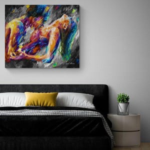 May include: Abstract painting depicting two figures in a passionate embrace. The artwork features vibrant colors including blues, yellows, and purples against a gray and black background. The painting is mounted on a wall above a bed.