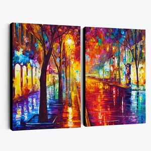May include: Two-panel canvas art featuring a vibrant, impressionistic street scene. The artwork depicts a tree-lined street with colorful reflections on a wet surface, illuminated by streetlights. The color palette includes blues, yellows, and reds.