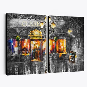 May include: A diptych canvas print of a street scene at night. The artwork depicts a building with the name "CLARE" in gold lettering above the entrance. The scene is primarily in grayscale with vibrant orange and yellow light emanating from the windows.