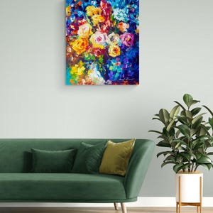 May include: An abstract floral painting with a vibrant display of colors. The artwork features a bouquet of roses in shades of yellow, orange, pink, and white against a deep blue background. The painting is displayed above a green sofa.