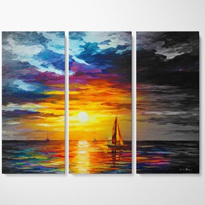 May include: A triptych canvas print depicting a sunset over the ocean. The sky transitions from blue and purple to vibrant orange and yellow, with a large sun. Sailboats dot the water, reflecting the colorful sky. The right panel is a grayscale version.