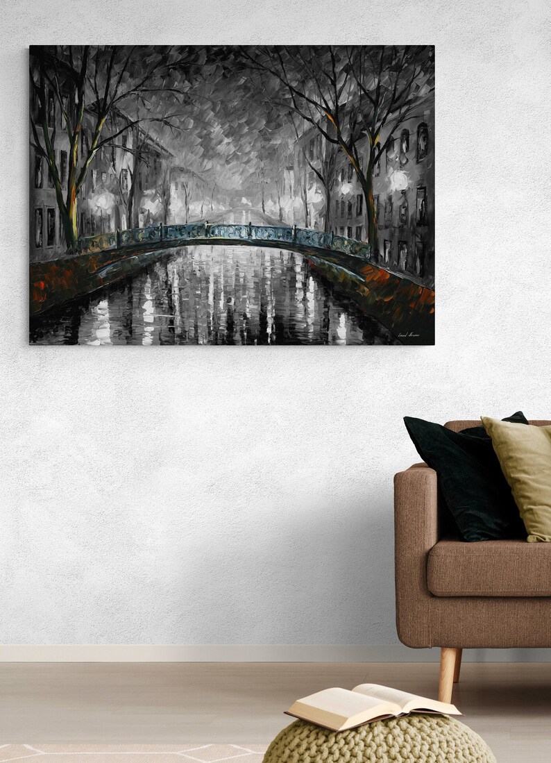 May include: A grayscale oil painting depicts a canal scene with a bridge and buildings. The bridge has a blue-green railing. Reflections of lights and buildings shimmer in the water. Bare trees frame the scene, adding a touch of nature to the urban landscape.
