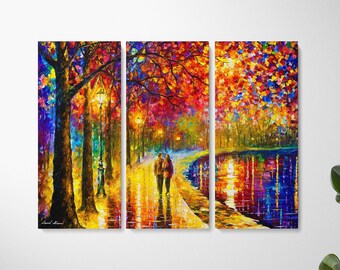 May include: A triptych canvas print showing an impressionistic park scene. The artwork features a couple walking along a path, trees with colourful foliage, and a reflective body of water. The colour palette includes reds, oranges, yellows, blues, and greens.