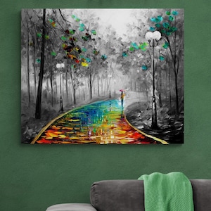 May include: A canvas print of a colorful, impressionistic landscape. A person with an umbrella walks along a vibrant, rainbow-colored path through a black and white forest. The artwork is displayed on a green wall, with a decorative garland above.
