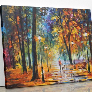 May include: A vibrant oil painting depicts a park scene in autumn. A person walks a dog along a wet path lined with lampposts and benches. The trees display a mix of orange, yellow, and red foliage.