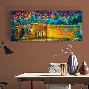 May include: An oil painting depicting a landscape with a building and colorful foliage. The artwork features a warm color palette with shades of orange, yellow, and brown, contrasted by cool blues and greens. The painting is rectangular and mounted on a wall.