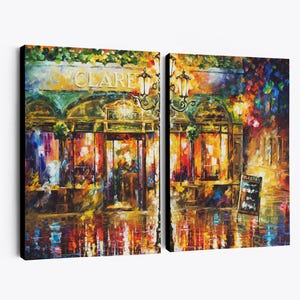 May include: A two-panel canvas print of a vibrant, impressionistic street scene at night. The artwork depicts a building with the name "CLARE" above the entrance, illuminated by warm, inviting lights. The scene is reflected in the wet pavement.