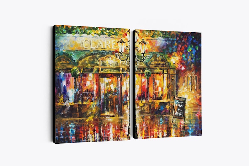 May include: A two-panel canvas print of a vibrant, impressionistic street scene at night. The artwork depicts a building with the name "CLARE" above the entrance, illuminated by warm, inviting lights. The scene is reflected in the wet pavement.