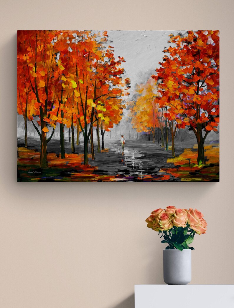 May include: An oil painting depicts a path lined with trees in autumn. The trees have vibrant orange and yellow leaves, contrasting with the gray sky and path. A figure walks in the distance, adding a sense of scale and depth to the artwork.