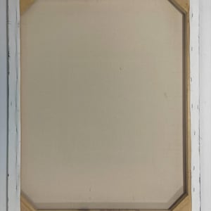 May include: Back of a stretched canvas art piece. The canvas is a light beige color, stretched over a wooden frame. The frame is visible, with the canvas wrapped around the edges and stapled to the wood. The edges of the frame are painted black.