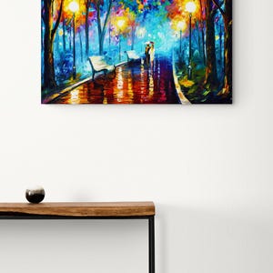 May include: A colorful oil painting depicts a park scene at night. The artwork features a couple walking under an umbrella on a wet path, illuminated by streetlights and surrounded by trees with vibrant foliage. Benches line the path.