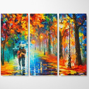 May include: A vibrant, three-panel canvas art piece depicting a couple walking under an umbrella in a colorful, impressionistic park scene. The artwork features a palette of blues, oranges, and yellows, with reflections on the wet ground and a lamppost.