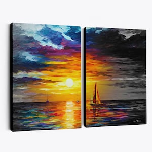 May include: A two-panel canvas art piece depicting a sunset over the ocean. The left panel shows a vibrant sunset with orange, yellow, blue, and purple hues. The right panel is a grayscale version of the same scene, with a sailboat.