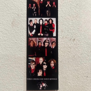 May include: A black and white vertical photo strip featuring the band My Chemical Romance. The top of the strip reads "MY ROMANCE." The bottom of the strip reads "THREE CHEERS FOR SWEET REVENGE."