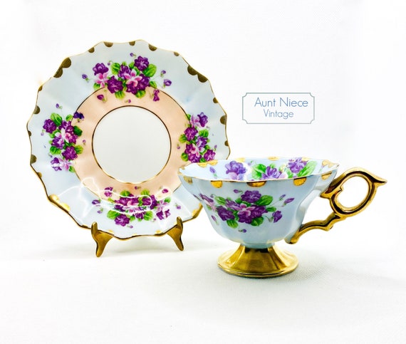 Vintage Lefton China Teacup and Saucer with Purple, gold and peach with lilacs violets ornate gold handle and pedestal cup