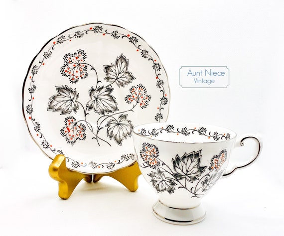 Vintage Tuscan Bone china teacup and saucer black leaves with hand painted orange red accents c. 1940s