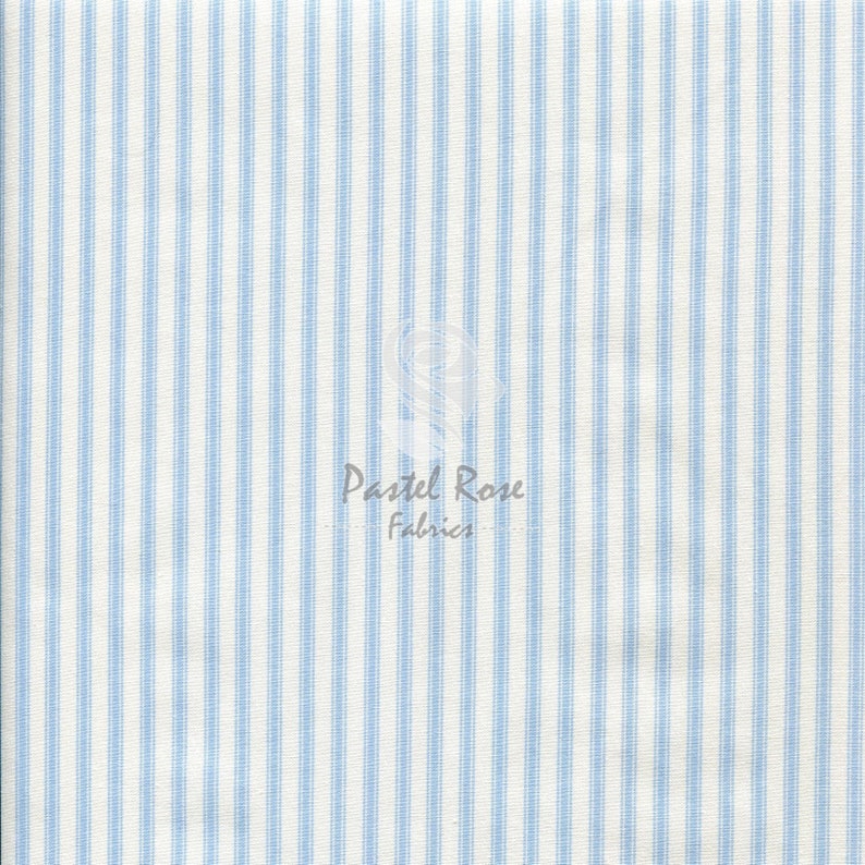 May include: White fabric with thin blue stripes. The fabric is woven and has a subtle texture. The fabric is perfect for sewing projects, quilting, and crafting.