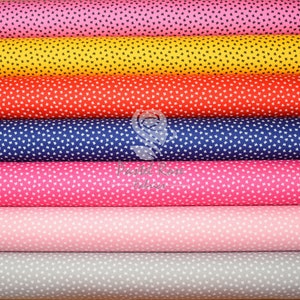 May include: A stack of six fabric rolls with a white background and small white stars printed on each roll. The rolls are in the following order from top to bottom: pink, yellow, red, navy blue, pink, light pink, and grey.