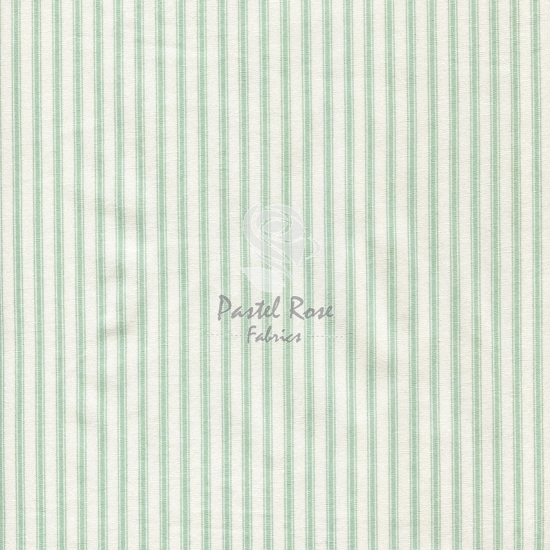 May include: White fabric with thin, evenly spaced green stripes. The fabric is a woven cotton blend.