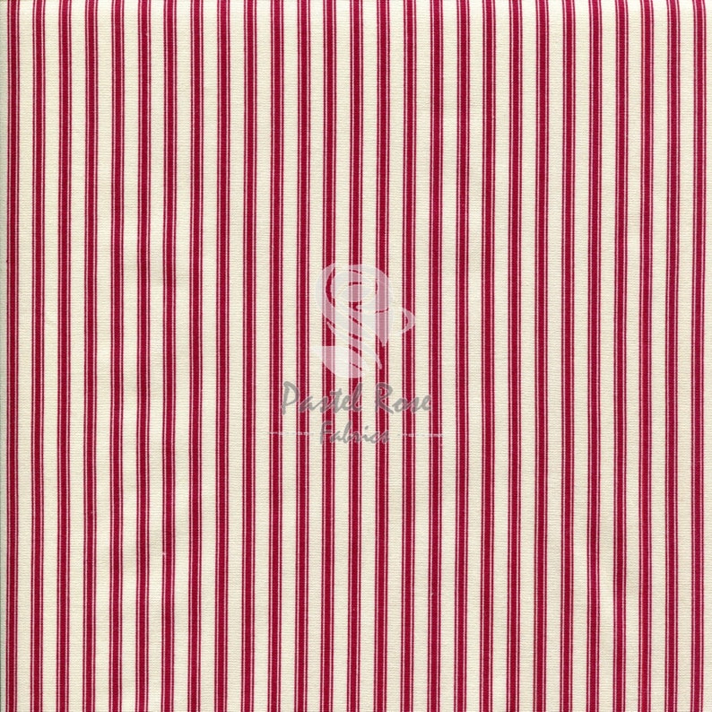 May include: Red and white striped fabric with a fine, vertical stripe pattern. The fabric is woven and has a slightly textured surface.