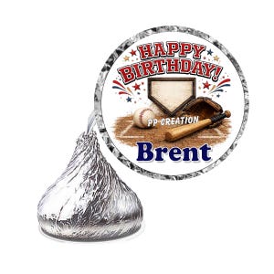 May include: A silver foil-wrapped chocolate candy with a circular sticker featuring a baseball theme. The sticker displays the text HAPPY BIRTHDAY, PP CREATION, and Brent, alongside a baseball, bat, glove, and home plate on a dirt field.