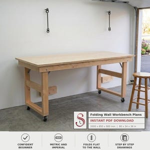 May include: A light-colored wooden folding wall workbench with a rectangular top and four legs on casters. The text on the image reads: Folding Wall Workbench Plans, INSTANT PDF DOWNLOAD, 2000 x 850 x 900 mm | 80 x 34 x 36 in.
