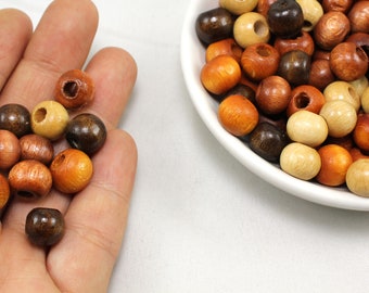 May include: A collection of wooden beads in various shades of brown, beige, and cream. The beads are round and have a smooth, polished finish. They are perfect for crafting jewelry, making garlands, or adding a rustic touch to home decor.