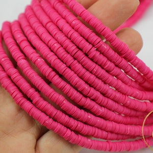 May include: A strand of bright pink round polymer clay beads. The beads are approximately 6mm in diameter and have a smooth, matte finish.