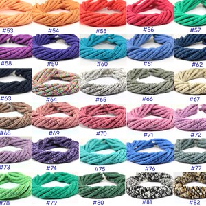 May include: A collection of 20 strands of colorful ceramic beads, each strand is approximately 18 inches long. The beads are made of clay and have a variety of textures and patterns. The beads are numbered from 53 to 82.
