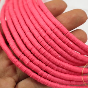 May include: A strand of bright pink polymer clay beads. The beads are small and round, and they are strung together on a clear thread. The beads are perfect for making jewelry or other crafts.