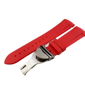 May include: Red silicone watch strap with a silver buckle. The strap is designed for a watch with a lug width of 22mm.