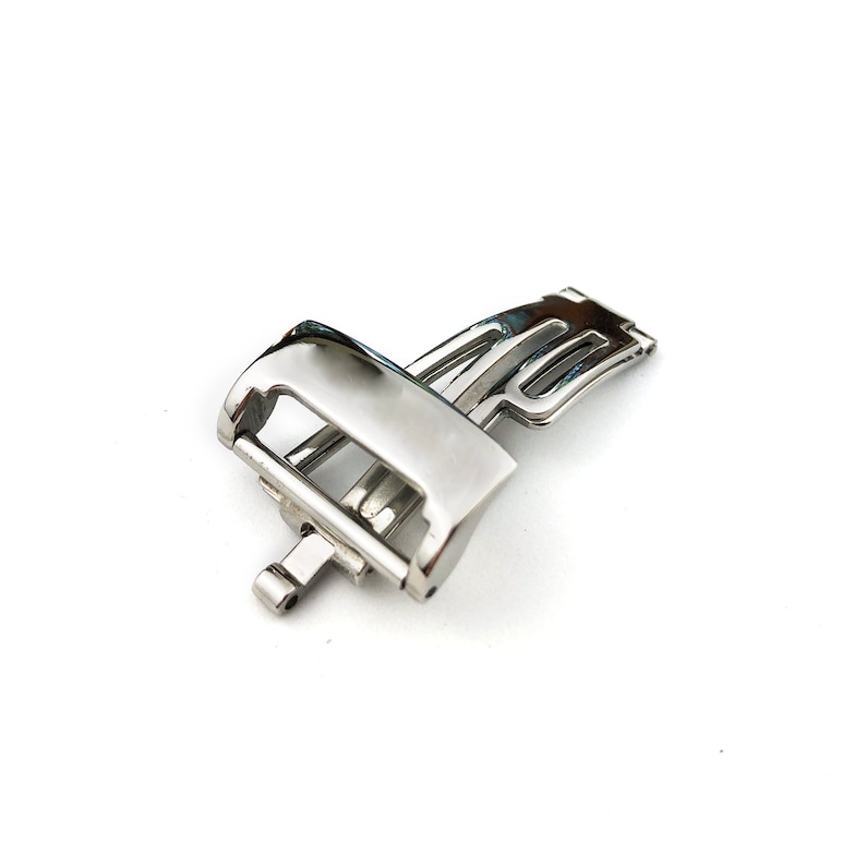 May include: A silver watch band clasp with a polished finish.
