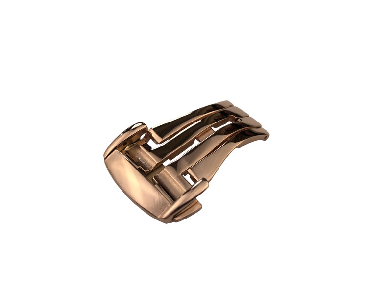 May include: A rose gold watch band buckle with a polished finish.