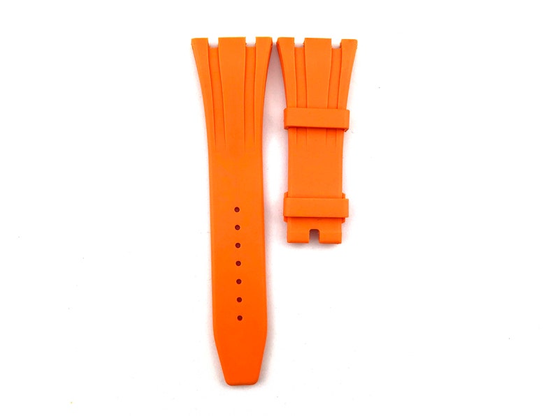 May include: Orange rubber watch strap with a buckle. The strap is designed for a watch with a lug width of 22mm.