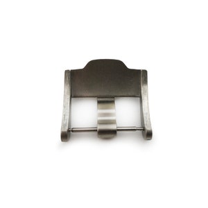 May include: A silver metal watch buckle with a smooth, brushed finish. The buckle has a simple, rectangular design with a single pin and a spring-loaded clasp.