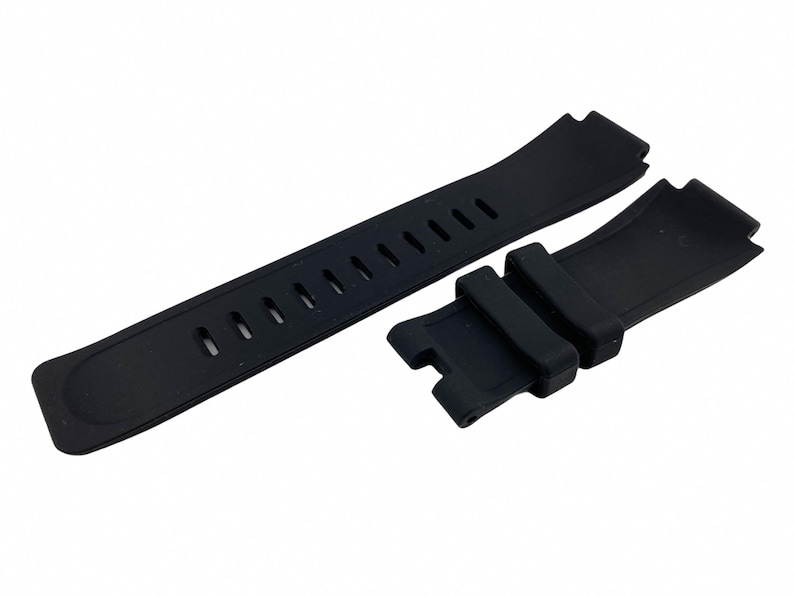 May include: Black rubber watch strap with a buckle and holes for adjusting the size.