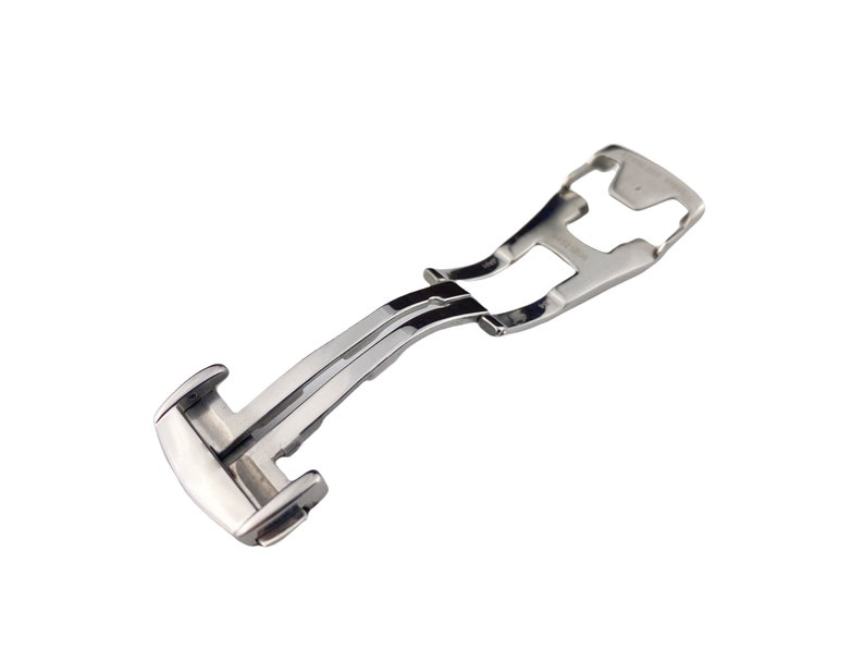 May include: A silver metal watch band clasp with a polished finish.