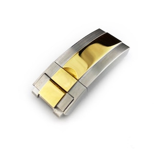 May include: A two-tone watch band clasp with a silver finish and a gold centre section.