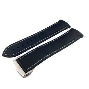 May include: Black rubber watch strap with white stitching and a silver buckle.